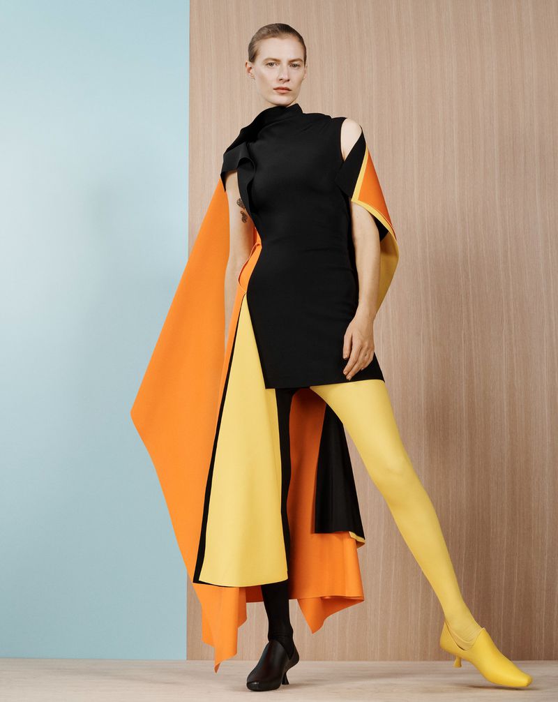 Model Julia Nobis wearing a black dress with orange and yellow panels for Financial Times HTSI Magazine