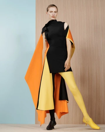 Model Julia Nobis wearing a black dress with orange and yellow panels for Financial Times HTSI Magazine