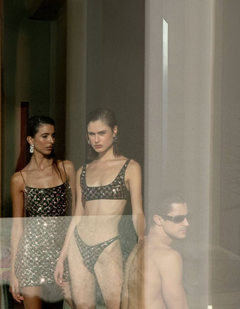Three models posed indoors featuring two women in sequined swimwear and a man in sunglasses with a double-exposure effect
