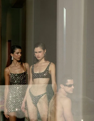 Three models posed indoors featuring two women in sequined swimwear and a man in sunglasses with a double-exposure effect