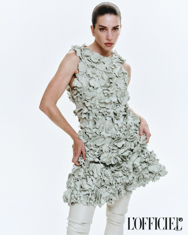 Model Valentina Ferrer wearing a textured sage green ruffle dress against a white studio background for L'Officiel Argentina.