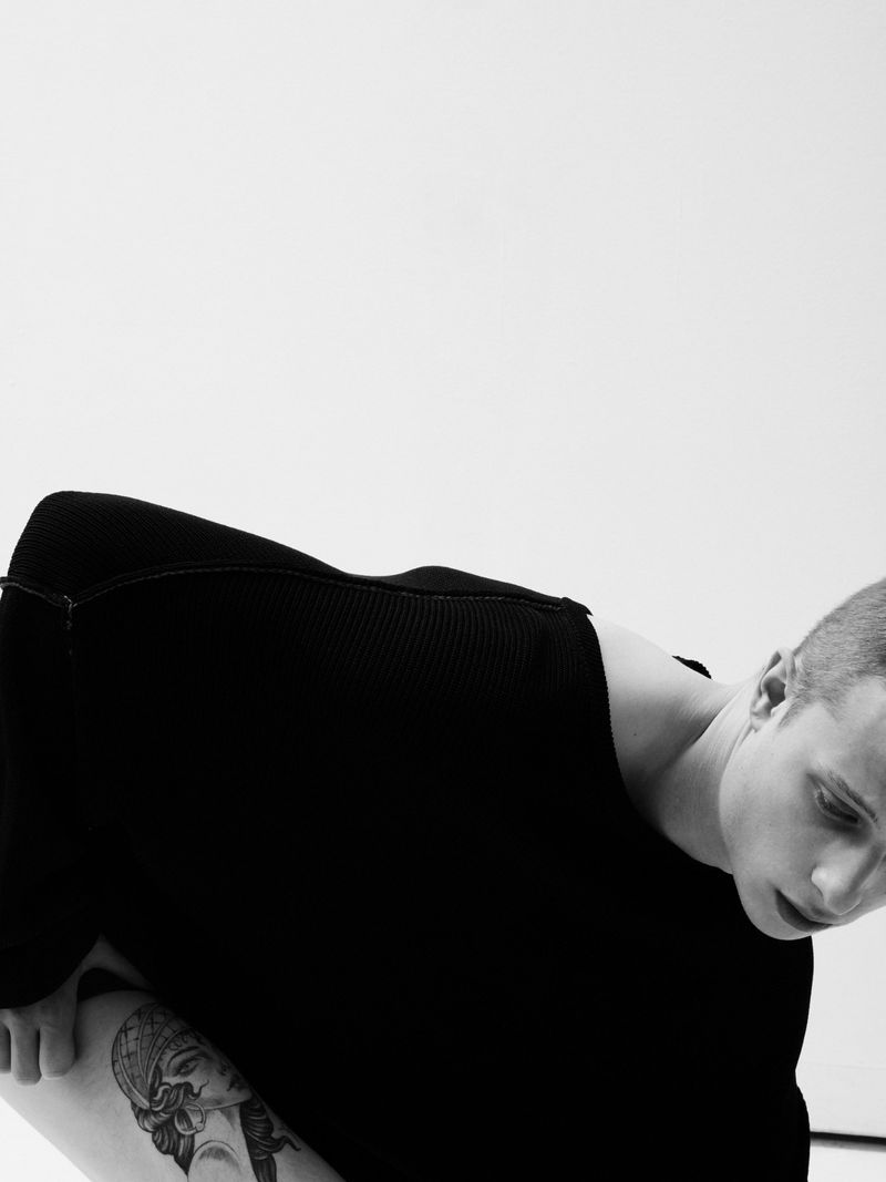 Close-up portrait of actor Francesco di Tullio wearing a black sweater against a white background, captured by photographer Alan Gelati.