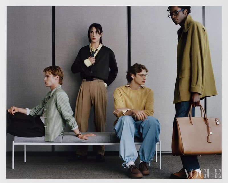 Four male models posing in a modern architectural interior for Vogue China Men editorial photography.