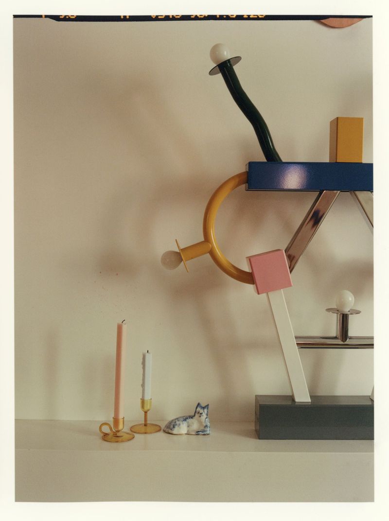 Scandibola sculptural object and small decorative candles displayed on a white shelf by Clément Pascal
