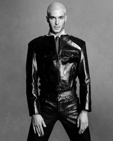 Fai Khadra wearing a black leather jacket and matching trousers in a monochrome portrait photographed by Luigi and Iango