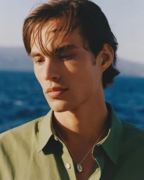 Portrait of Louis Baines wearing a green shirt against an ocean background for Zara Man Spring 2026.