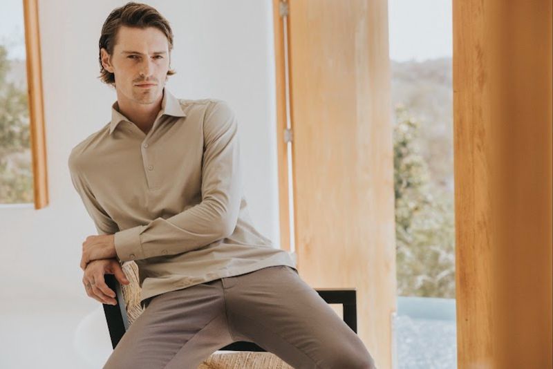 Model Myles Crosby seated wearing a beige long sleeve shirt and trousers for Scappino SS 2026 campaign photographed by Santiago Ruisenor.