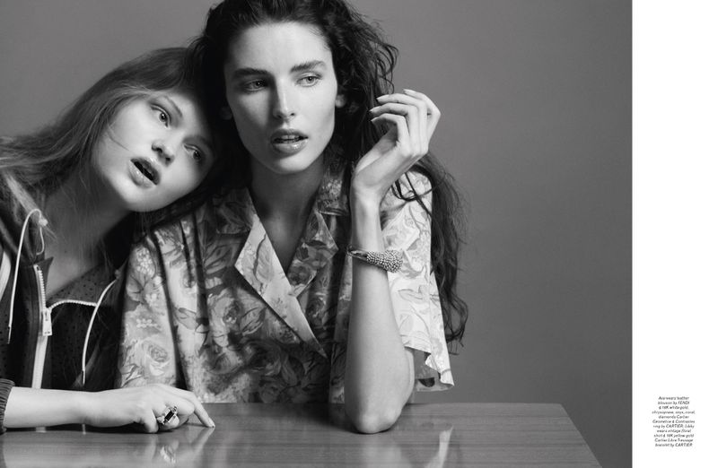 Two female models posing together in black and white for a Pop Magazine editorial shot against a grey studio backdrop.