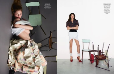 Two fashion models posing among scattered chairs for Pop Magazine editorial photographed by Vito Fernicola