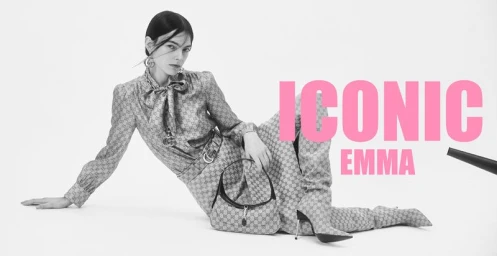 Model Emma Cabrespines seated against white background wearing patterned outfit and holding handbag