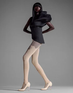 Model Ajok Madel wearing structured black top and patterned tights in a fashion editorial for Enfnts Terribles, photographed by Yis Kid.