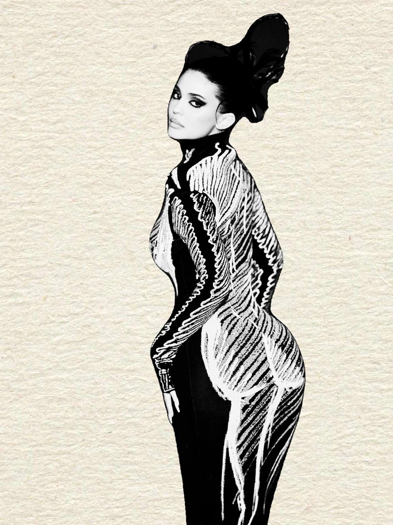 Kylie Jenner in a black and white graphic patterned catsuit against a textured off-white background.