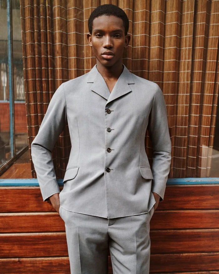 Model Ibra Niakate wearing a grey suit jacket for Farfetch Lookbook S/S 26
