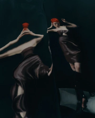 Elegant woman in a dark dress and red hair poses in a surreal studio environment, reflected in a distorted mirror with dark color grading.
