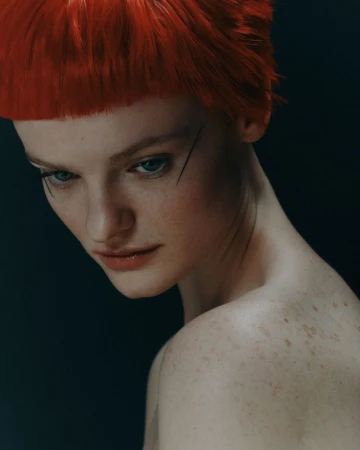 Close-up portrait of a woman with red hair and freckles against a dark background, showcasing fashion and beauty elements.