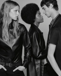 Monochrome fashion portrait of three models posing against a neutral backdrop for Calvin Klein campaign.