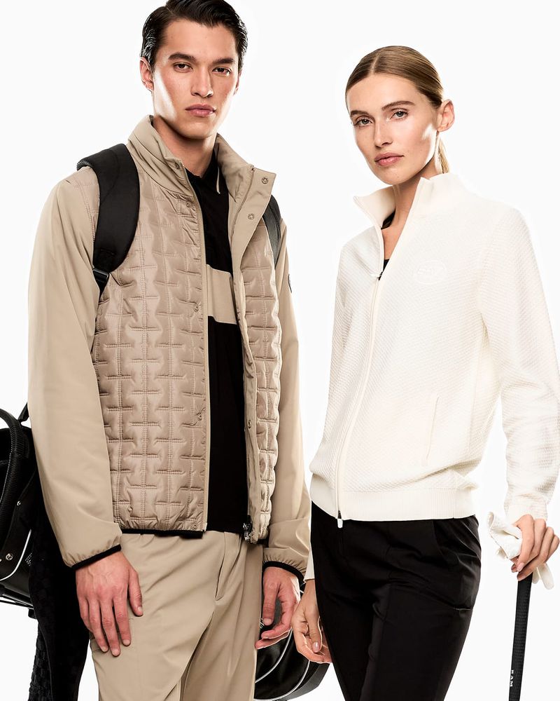 Two models showcase modern golf apparel: a man in a vest with a golf bag, and a woman in a jacket, both with neutral expressions.
