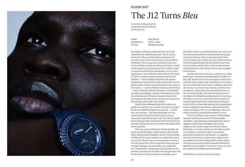Close-up of a dark-skinned model wearing a blue Chanel watch, face partially painted white, striking fashion and beauty portrait.