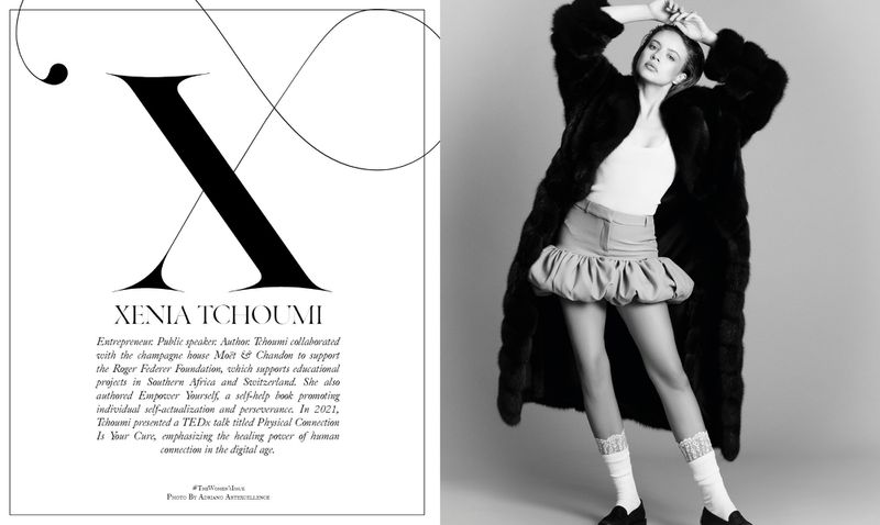 Black-and-white fashion portrait of a woman in a dark fur coat and light skirt, standing in a studio with a typographic design.