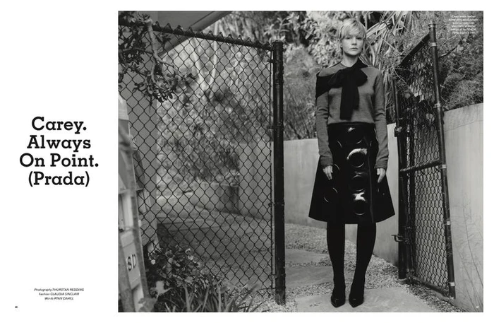 Carey Mulligan standing before a chain-link fence in Pop Magazine editorial photography by Thurstan Redding