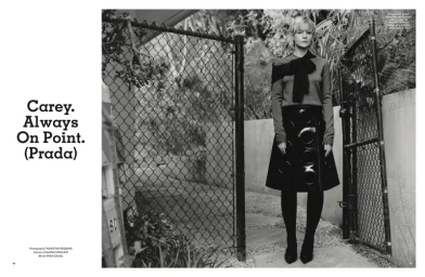 Carey Mulligan standing before a chain-link fence in Pop Magazine editorial photography by Thurstan Redding