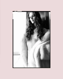 Black and white portrait of model Libby Taverner in lace lingerie and faux fur coat by photographers Luigi and Iango.
