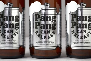 Close-up product shot of PangPang Brewery beer bottles featuring metallic silver labels with bold black typography.