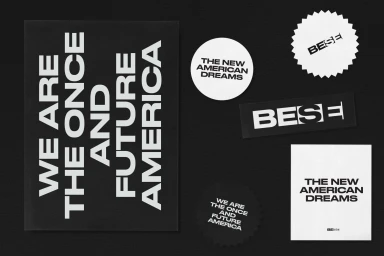 Monochrome flat lay showcasing BESE brand identity elements including typography posters and stickers on a dark background