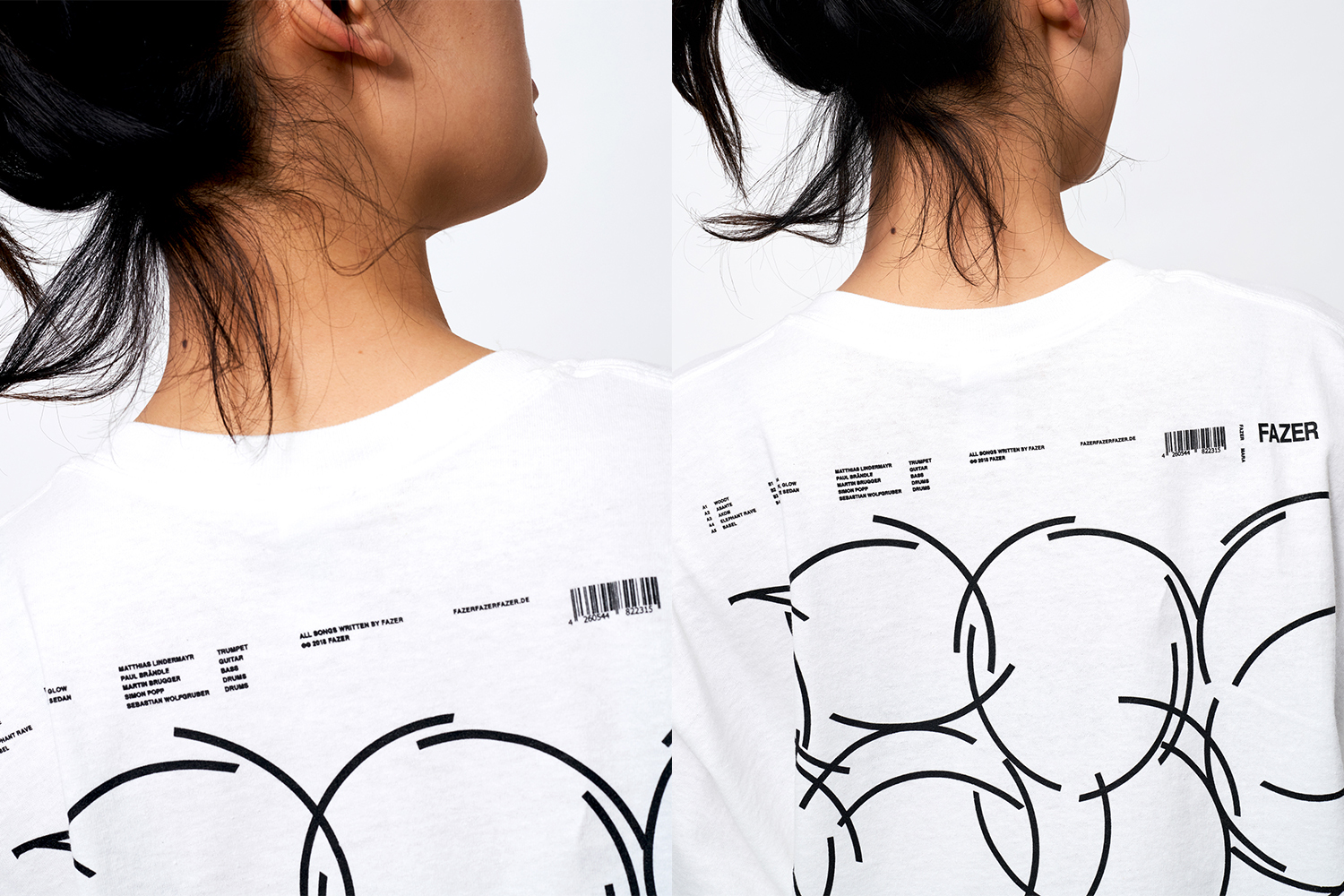 Close-up of a person wearing a white t-shirt featuring black graphic prints and typography on the back against a plain white background.