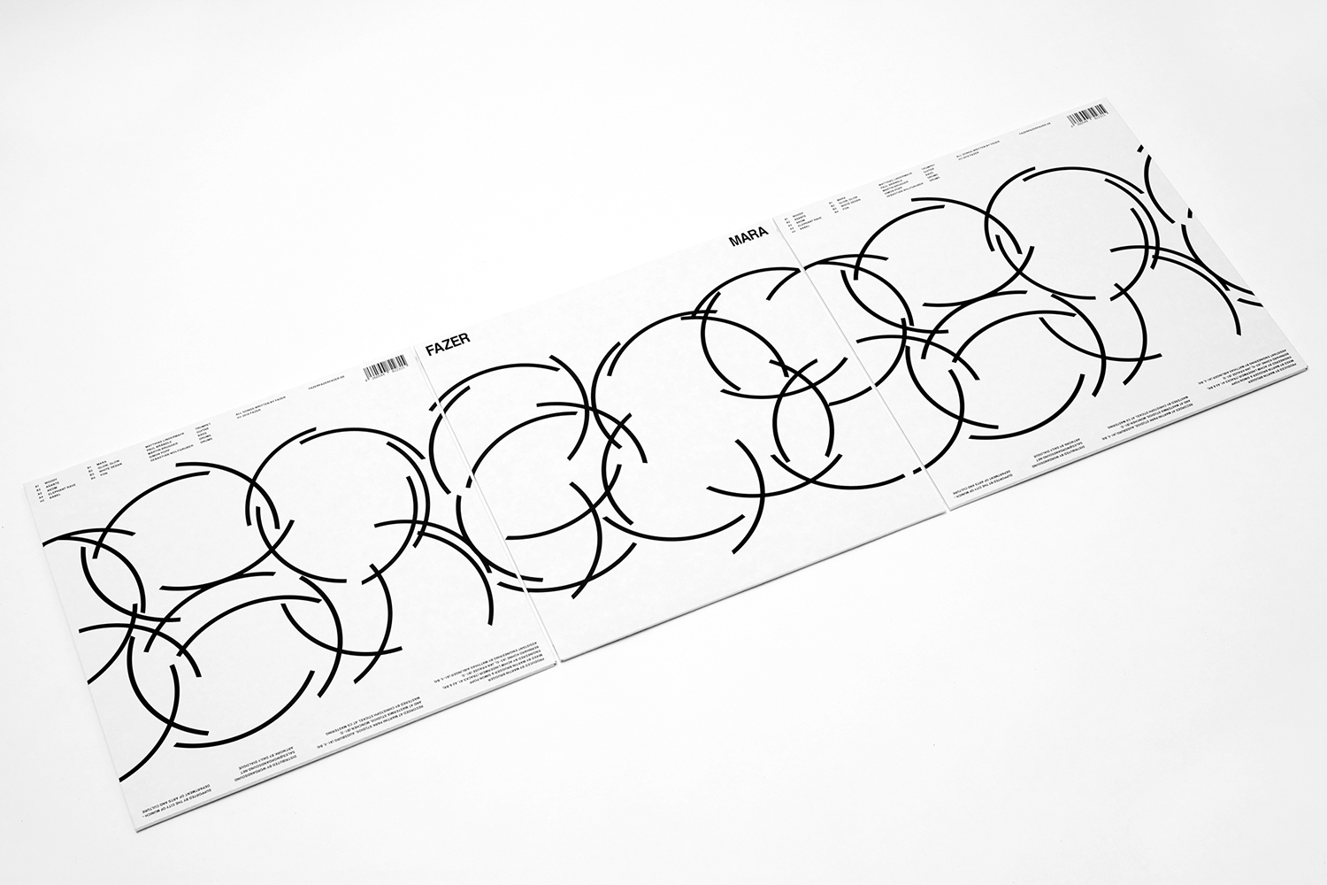 FAZER brand identity packaging design with black geometric circle patterns on white panels against a clean background.