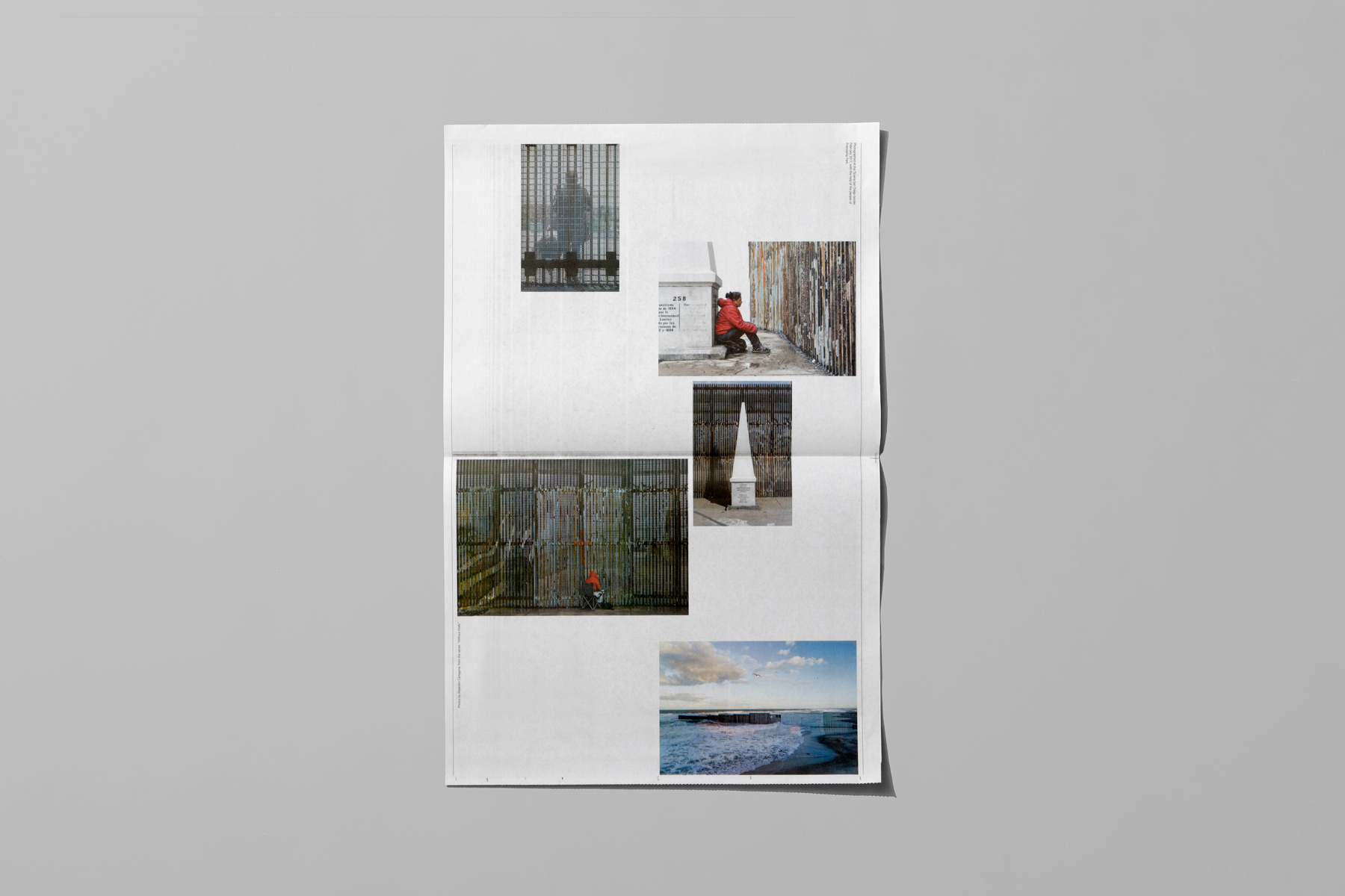 Open newspaper layout displaying a collage of photographic prints on a grey surface.