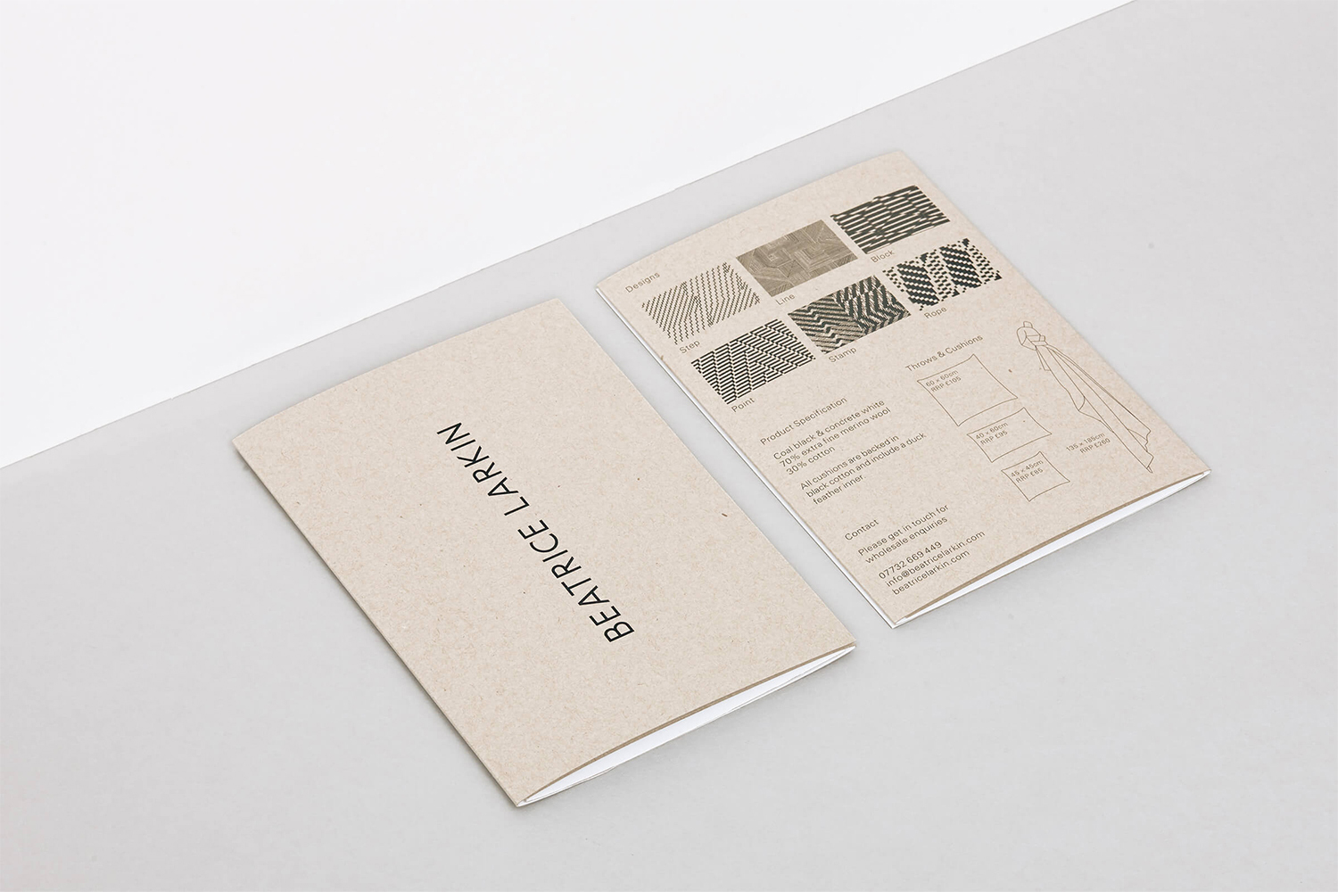 Two printed Beatrice Larkin brand identity brochures resting flat on a clean grey studio surface.