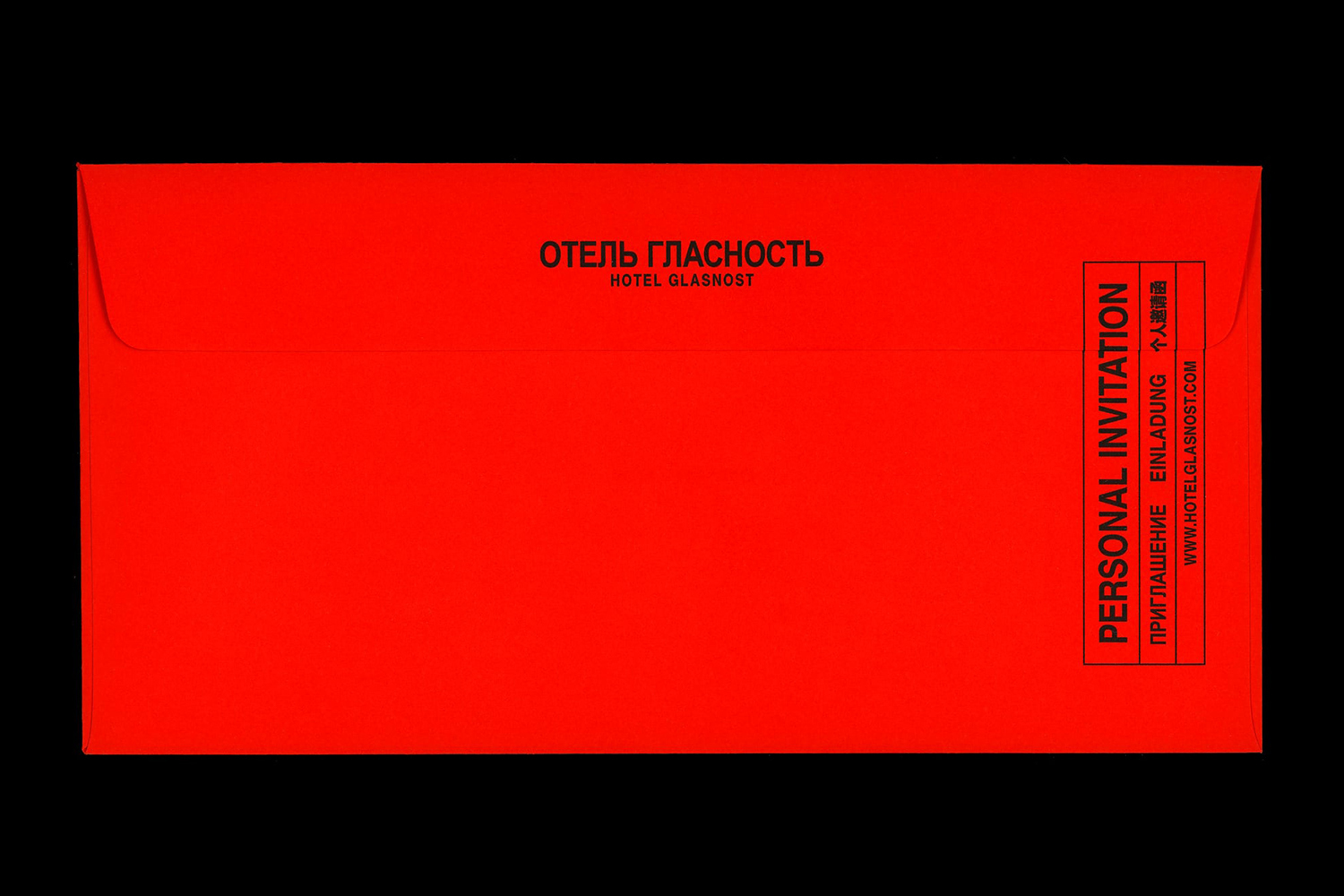Vibrant red envelope with black typography against a dark background for Hotel Glasnost brand identity