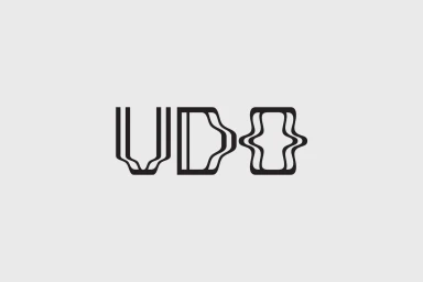 Black graphic typography logo for UDO centered against a solid light grey background.