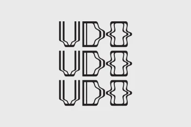 Black minimalist typographic logo design spelling UDO arranged in three rows against a neutral light grey background.