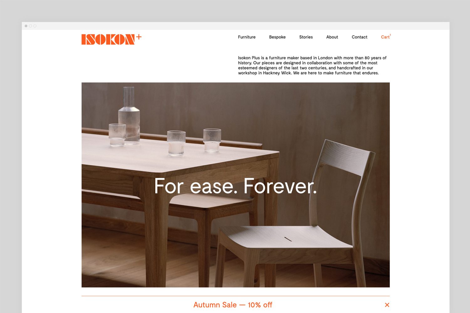 Isokon Furniture Company brand identity website mockup featuring a wooden dining table and chairs with glassware.