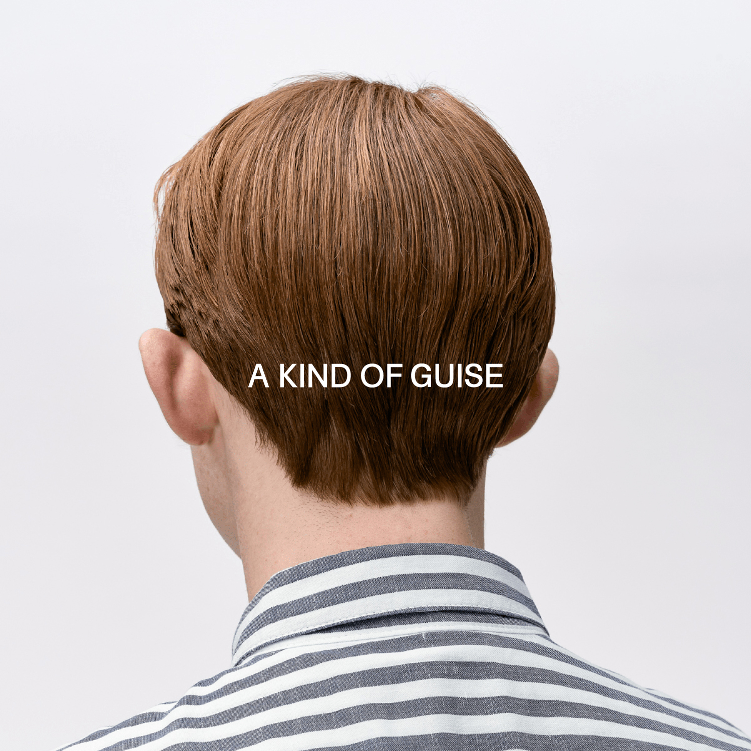 Rear view of a person with short brown hair wearing a striped shirt against a plain white background with brand text