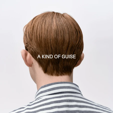 Rear view of a person with short brown hair wearing a striped shirt against a plain white background with brand text