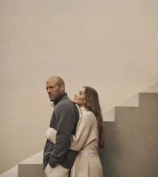 Jason Statham and Rosie Huntington-Whiteley embracing on stone stairs for the Falconeri Fall 2025 campaign.