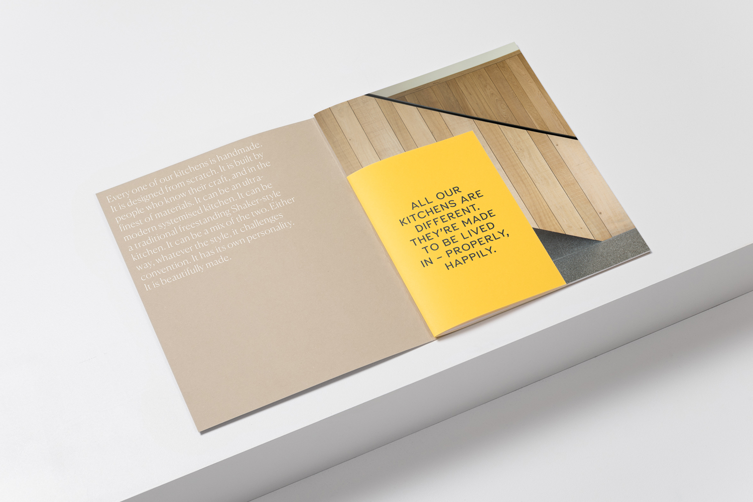 Open brochure featuring a yellow insert with bold black text on a white angled surface