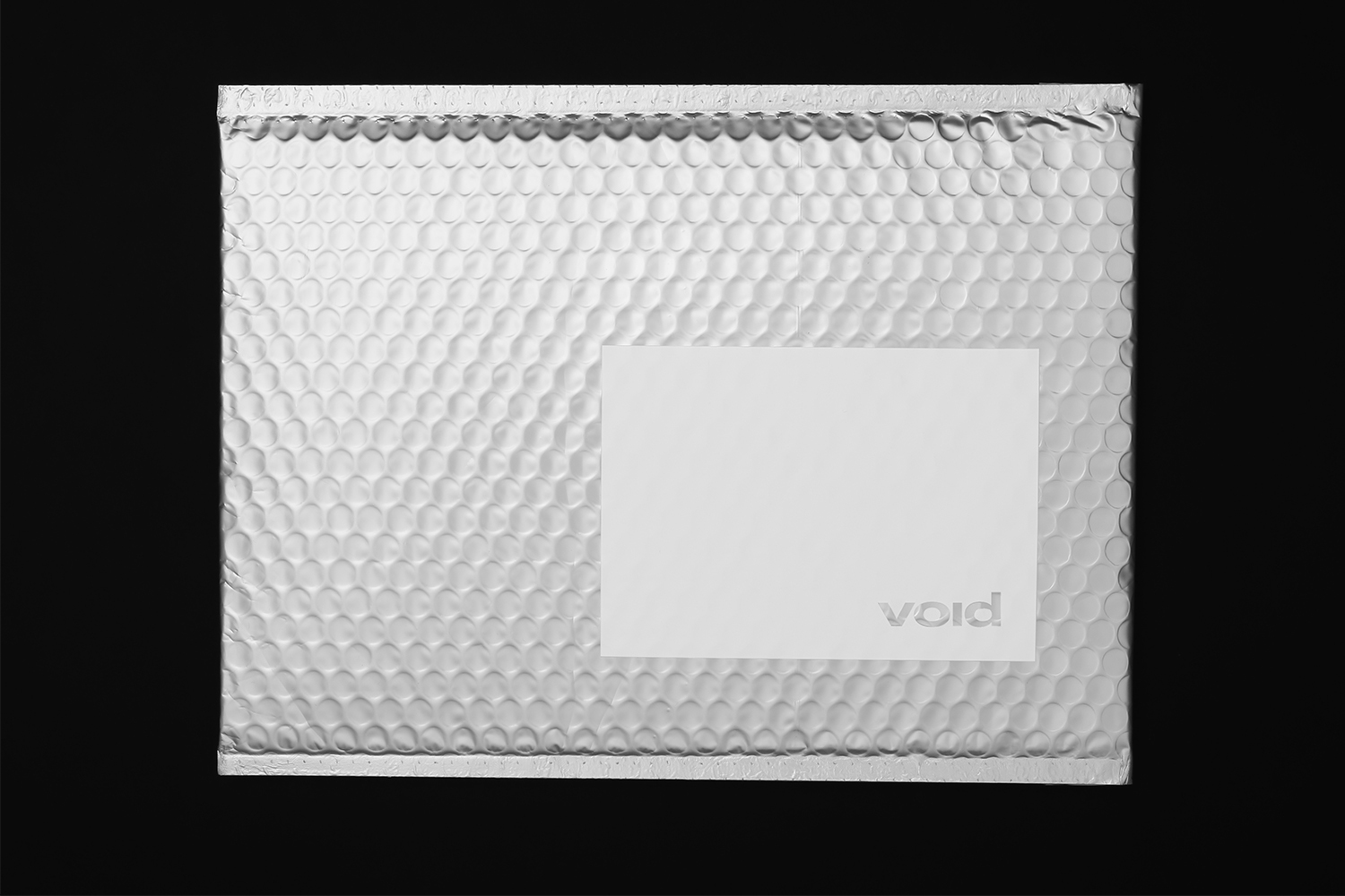 Silver bubble mailer packaging with a central white label featuring the Void brand name on a dark background