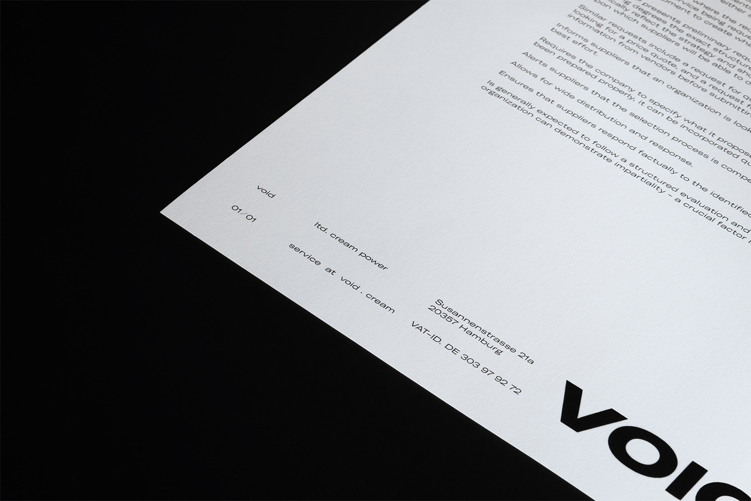 Printed document on white paper resting on a black surface showing minimalist typography and Void brand typography details.