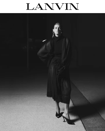 Model standing in a black outfit on a dark street at night for Lanvin fashion editorial campaign.