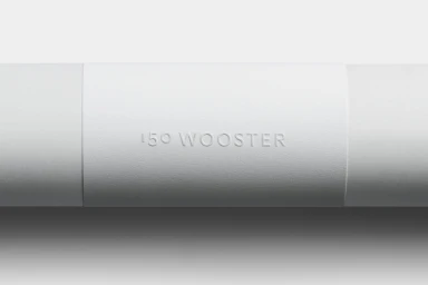 Embossed paper band wrapping around a white cylinder featuring 150 Wooster brand identity design by Javas Lehn Studio.
