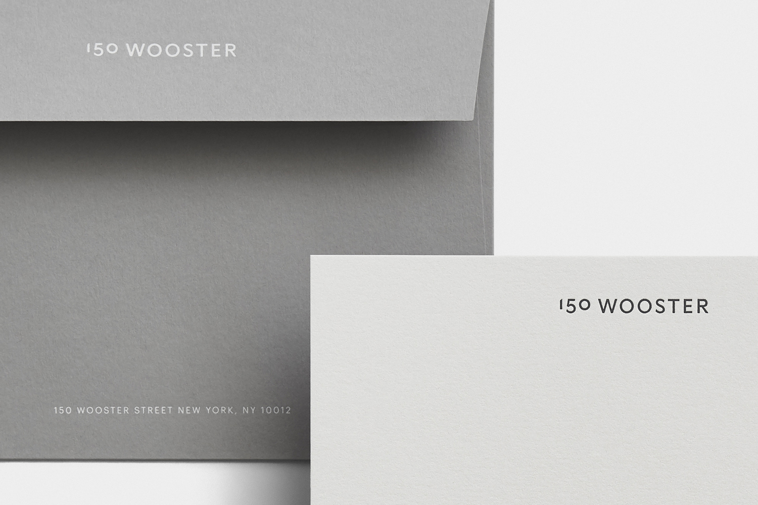 Minimalist stationery featuring grey envelope and white card with 150 Wooster branding designed by Javas Lehn Studio.
