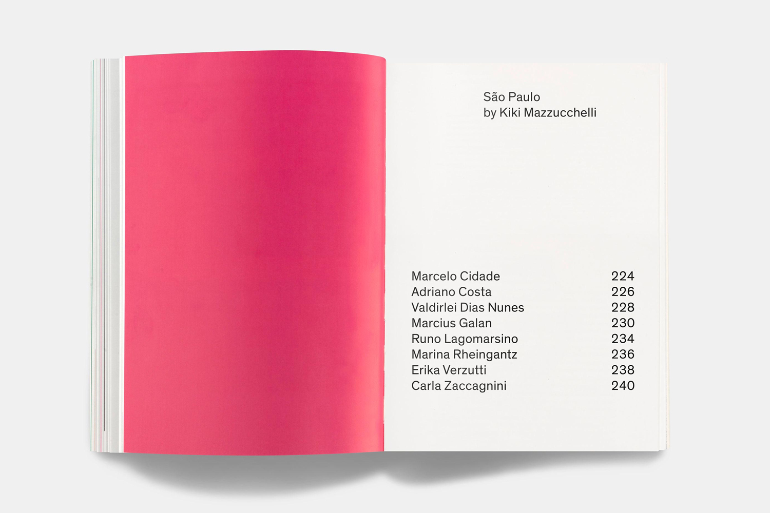 Open book spread showing a vibrant magenta page on the left and a contents page with black typography on the right