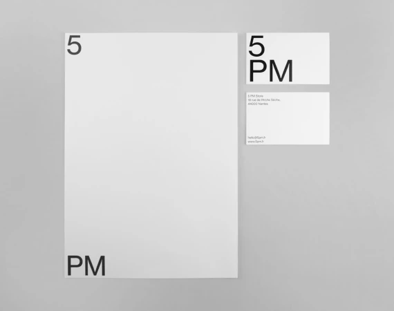 Minimalist brand identity stationery featuring the 5PM logo on white paper against a neutral grey surface.