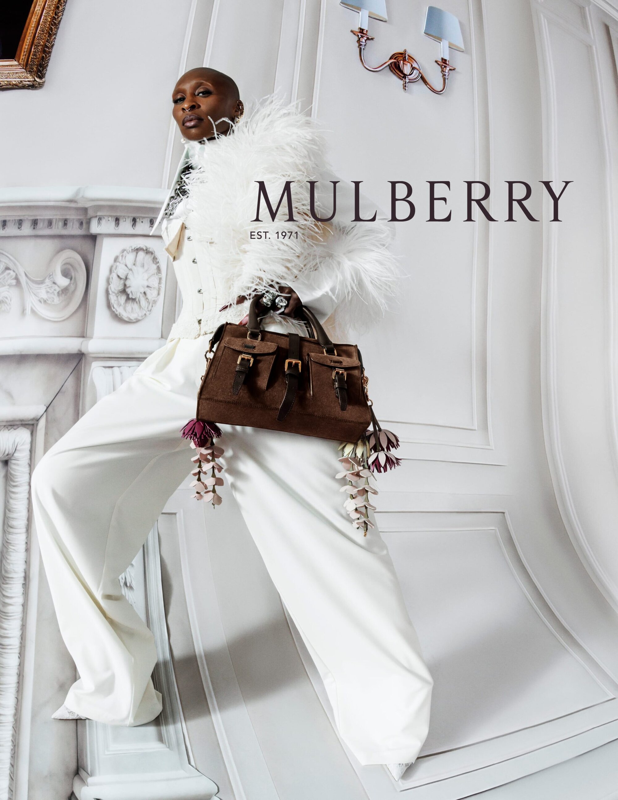 Cynthia Erivo wearing white attire with feathered trim and holding a brown leather handbag for Mulberry Spring 2026 ad campaign