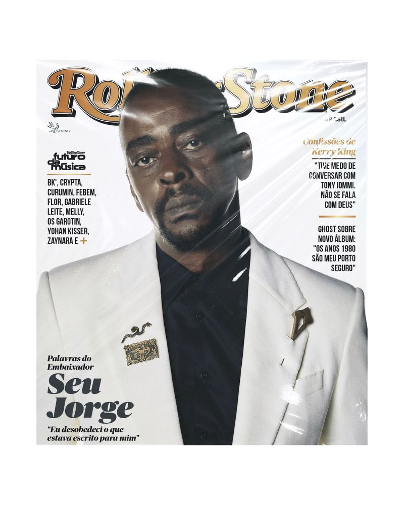 Rolling Stone magazine cover featuring Seu Jorge in a white suit against a white background, with magazine text and cover lines.