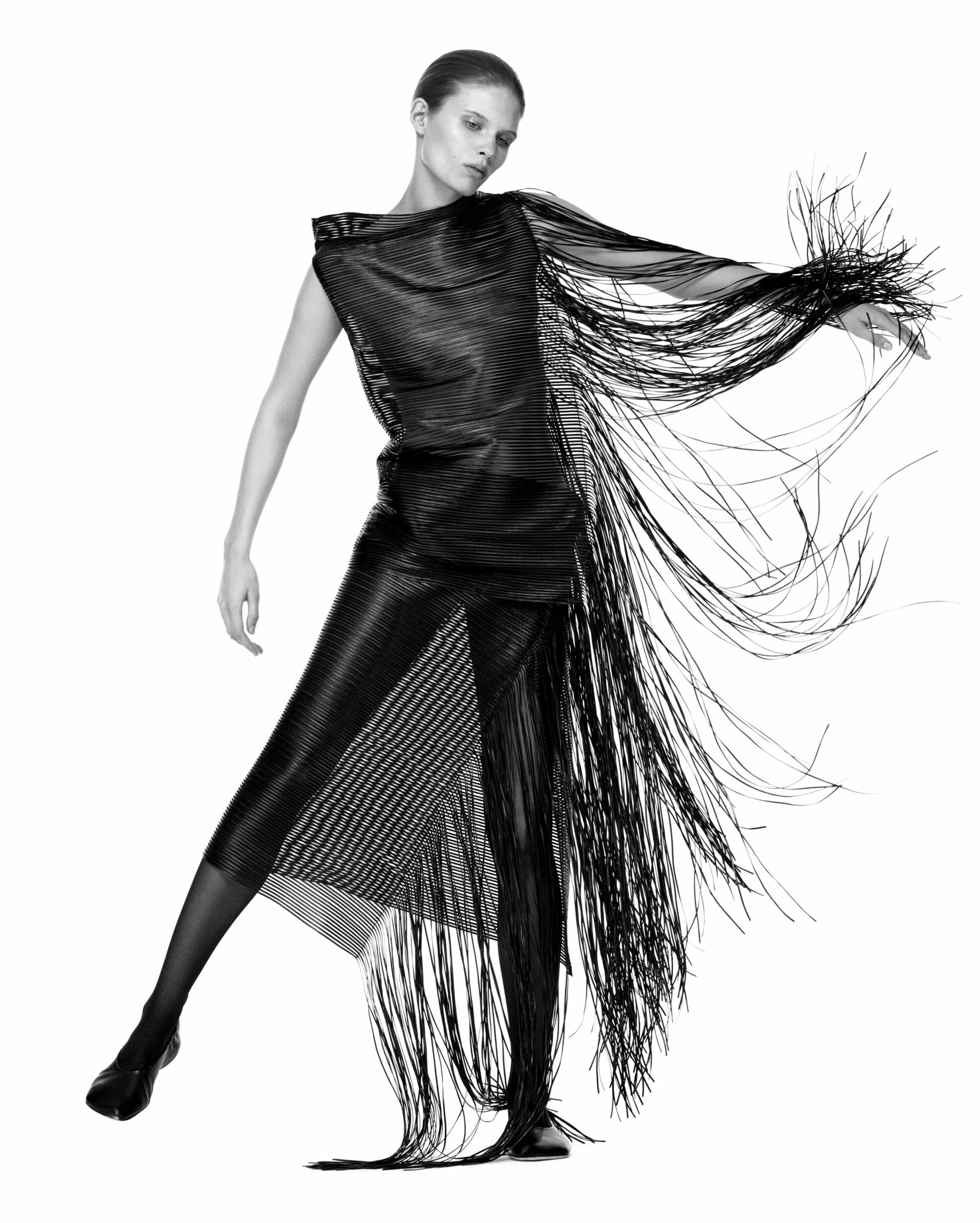 Model Ida Heiner wearing a black fringed dress in a studio campaign shot for Sportmax photographed by Julien Martinez Leclerc